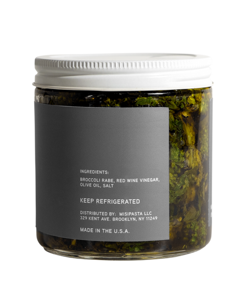 Jar of pickled vegetables with a gray label on a white background