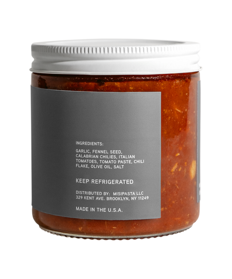 Jar of pasta sauce with a gray label on a white background