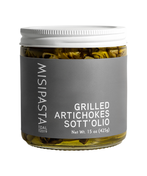 Jar of Misipasta grilled artichokes sott'olio on a white background