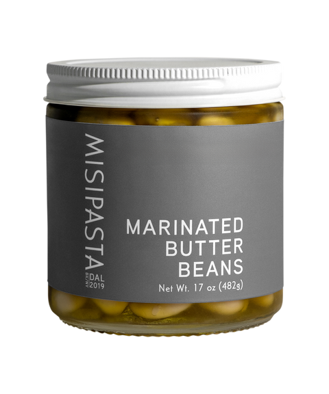 Jar of Misipasta marinated butter beans on a white background